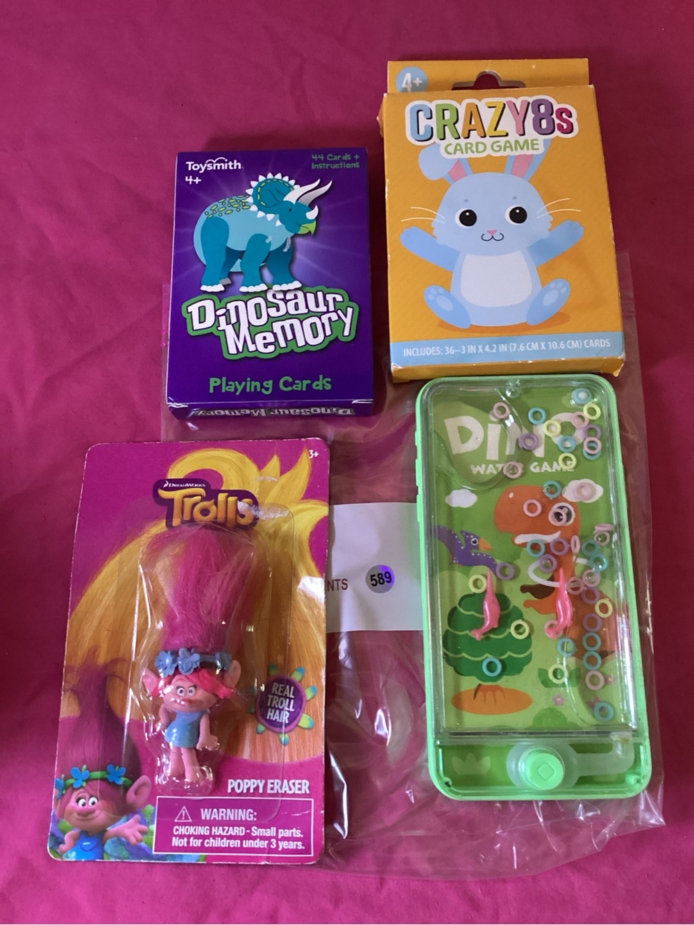 589-Lot of Various Kids Toys Card Games, Trolls Poppy Eraser & Dino Water Game